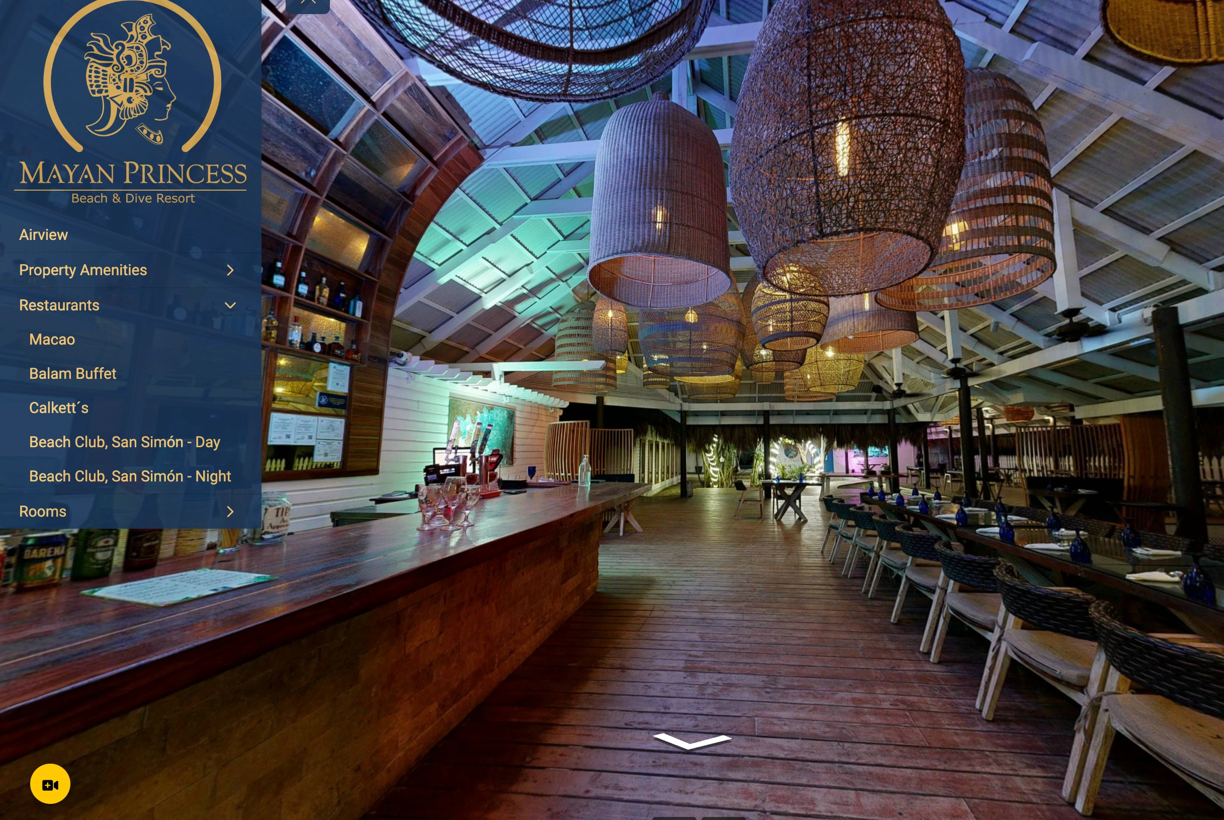 Spacious restaurant interior with wooden floor, long bar counter, woven pendant lights, and dining tables with chairs.