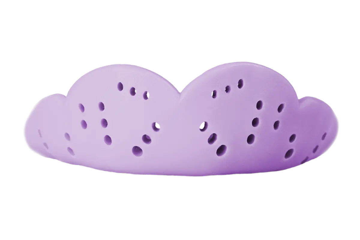 Lavender-colored curved silicone or rubber bed mitten with multiple ventilation holes.