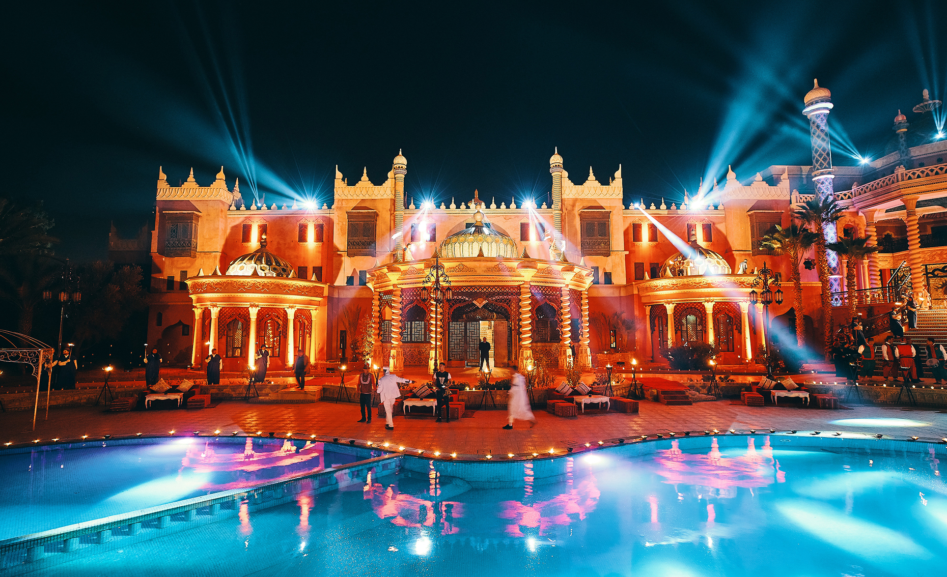Sunlight shining through hanging white flowers and green leaves in an outdoor setting.