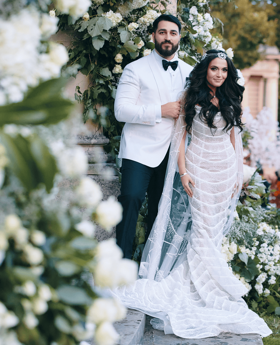 Sunlight shining through hanging white flowers and green leaves in an outdoor setting.