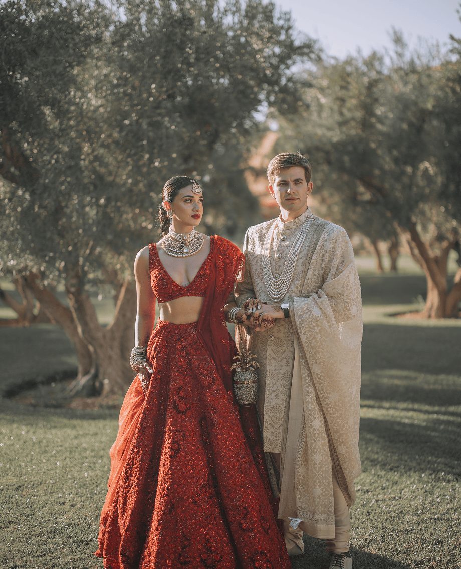 Sunlight shining through hanging white flowers and green leaves in an outdoor setting.