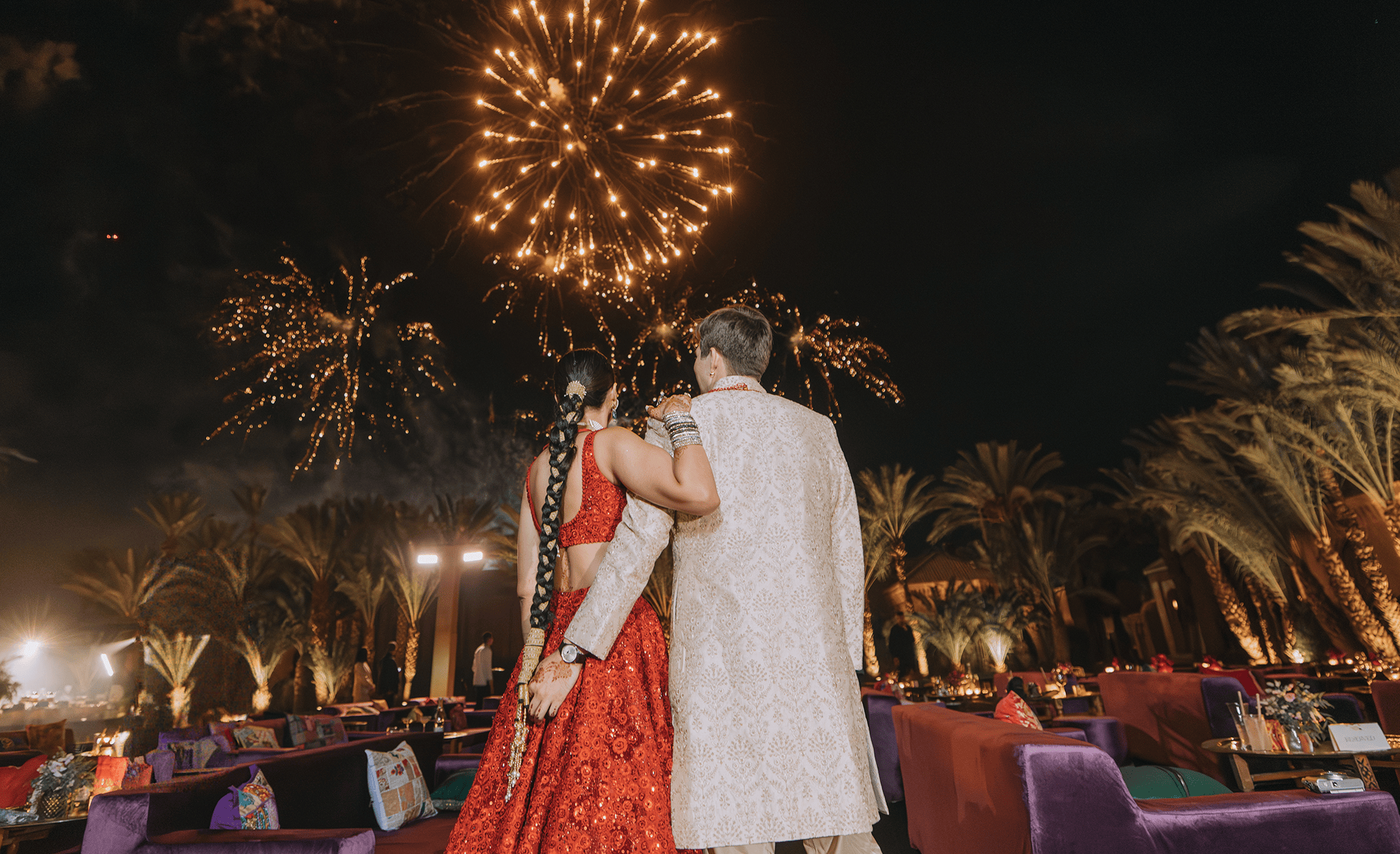 Sunlight shining through hanging white flowers and green leaves in an outdoor setting.
