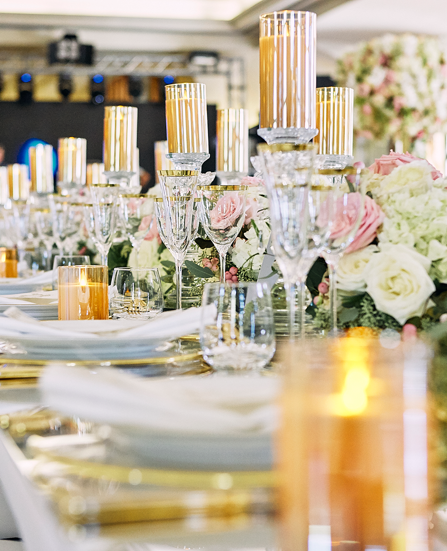 Sunlight shining through hanging white flowers and green leaves in an outdoor setting.