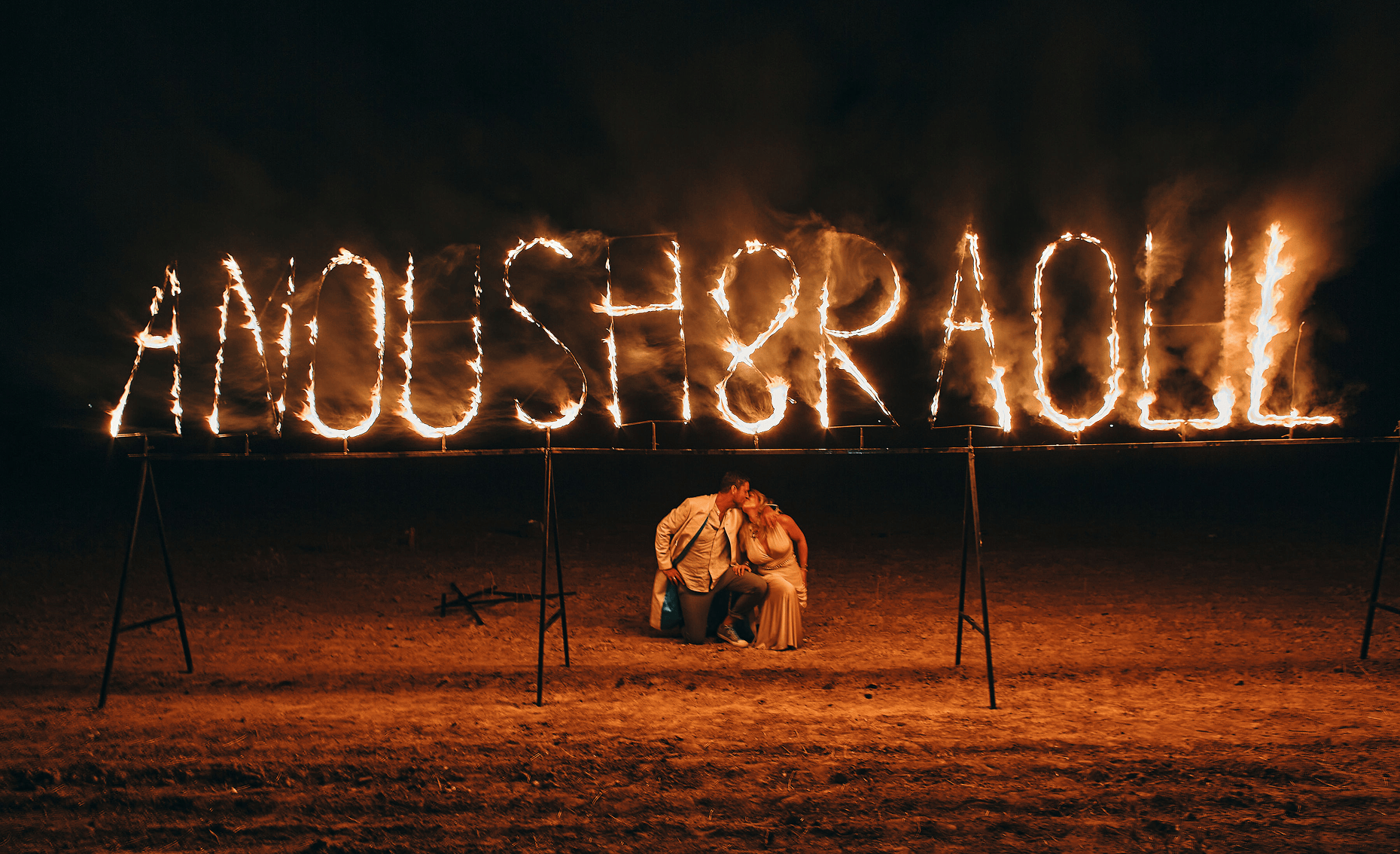 Sunlight shining through hanging white flowers and green leaves in an outdoor setting.