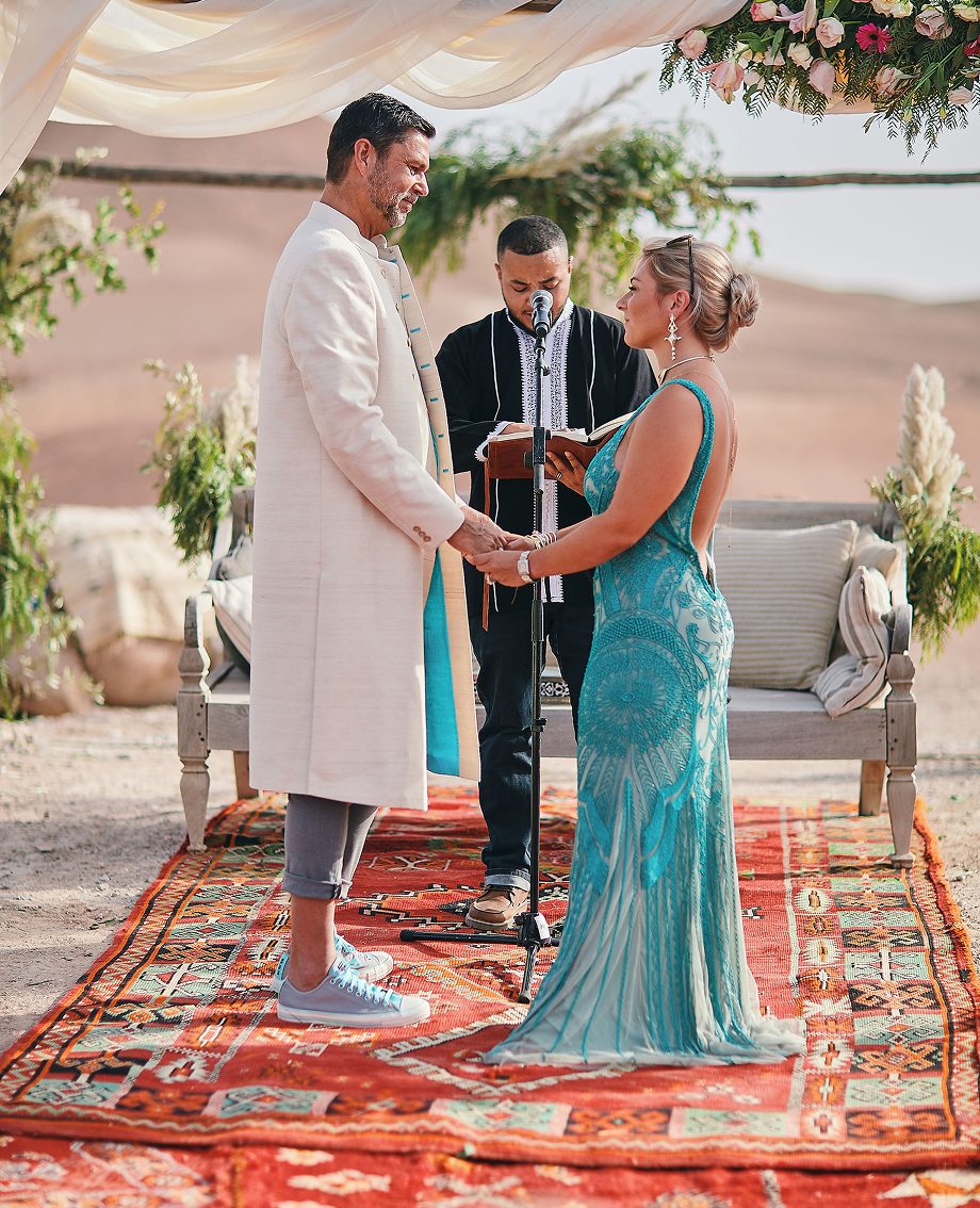 Sunlight shining through hanging white flowers and green leaves in an outdoor setting.