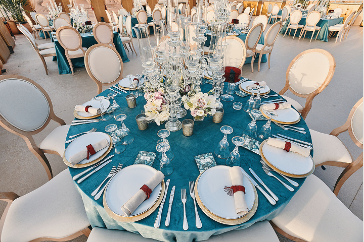 Sunlight shining through hanging white flowers and green foliage decorations.