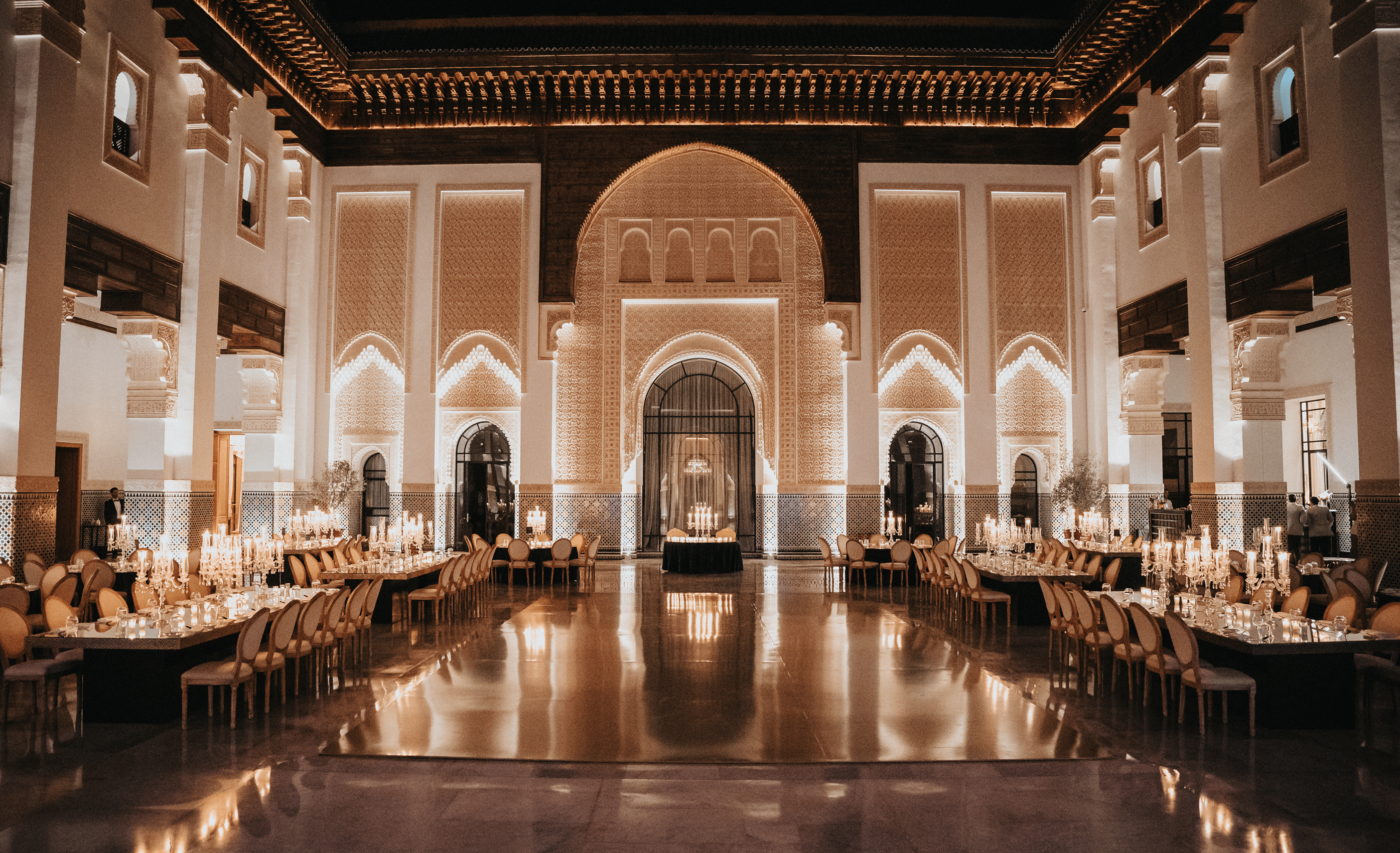 Sunlight shining through hanging white flowers and green leaves in an outdoor setting.