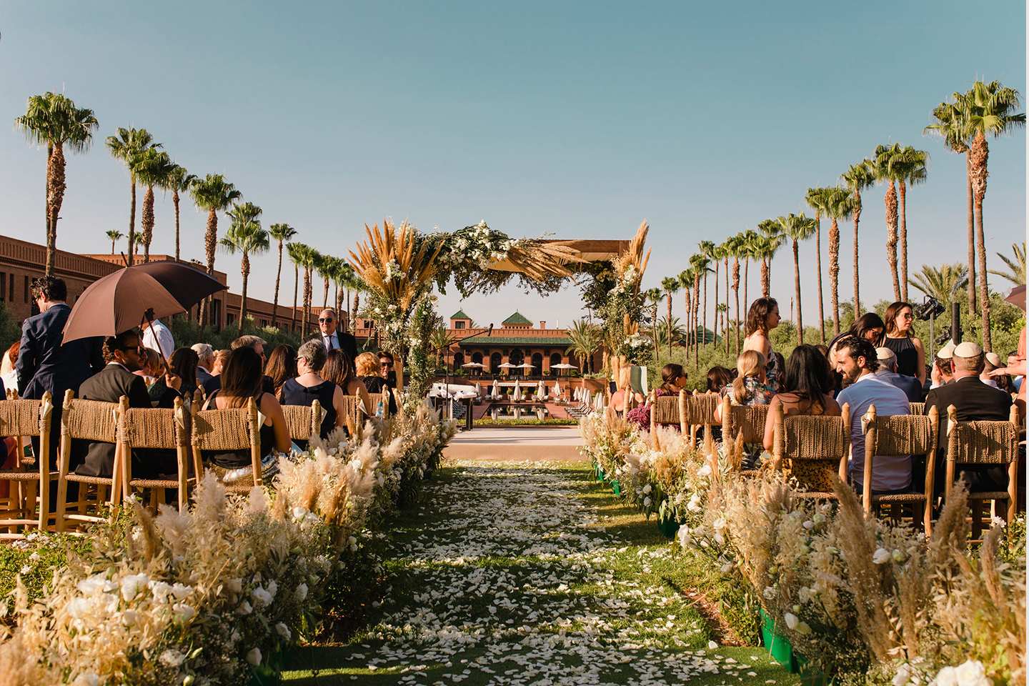 Sunlight shining through hanging white flowers and green foliage decorations.