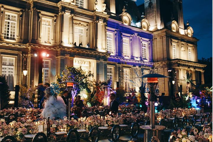 Sunlight shining through hanging white flowers and green foliage decorations.