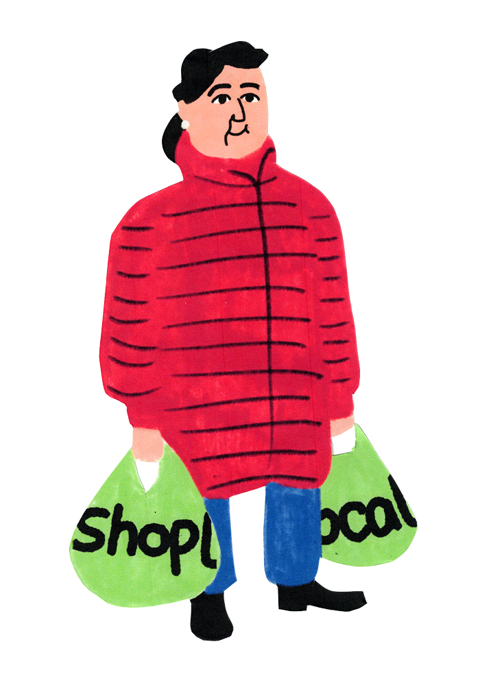 An illustration of a woman with dark hair and a white earing, smiling in a red coat as she carries bags that have the words shop local on them