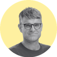 A yellow circle with a black and white photo portrait over the top