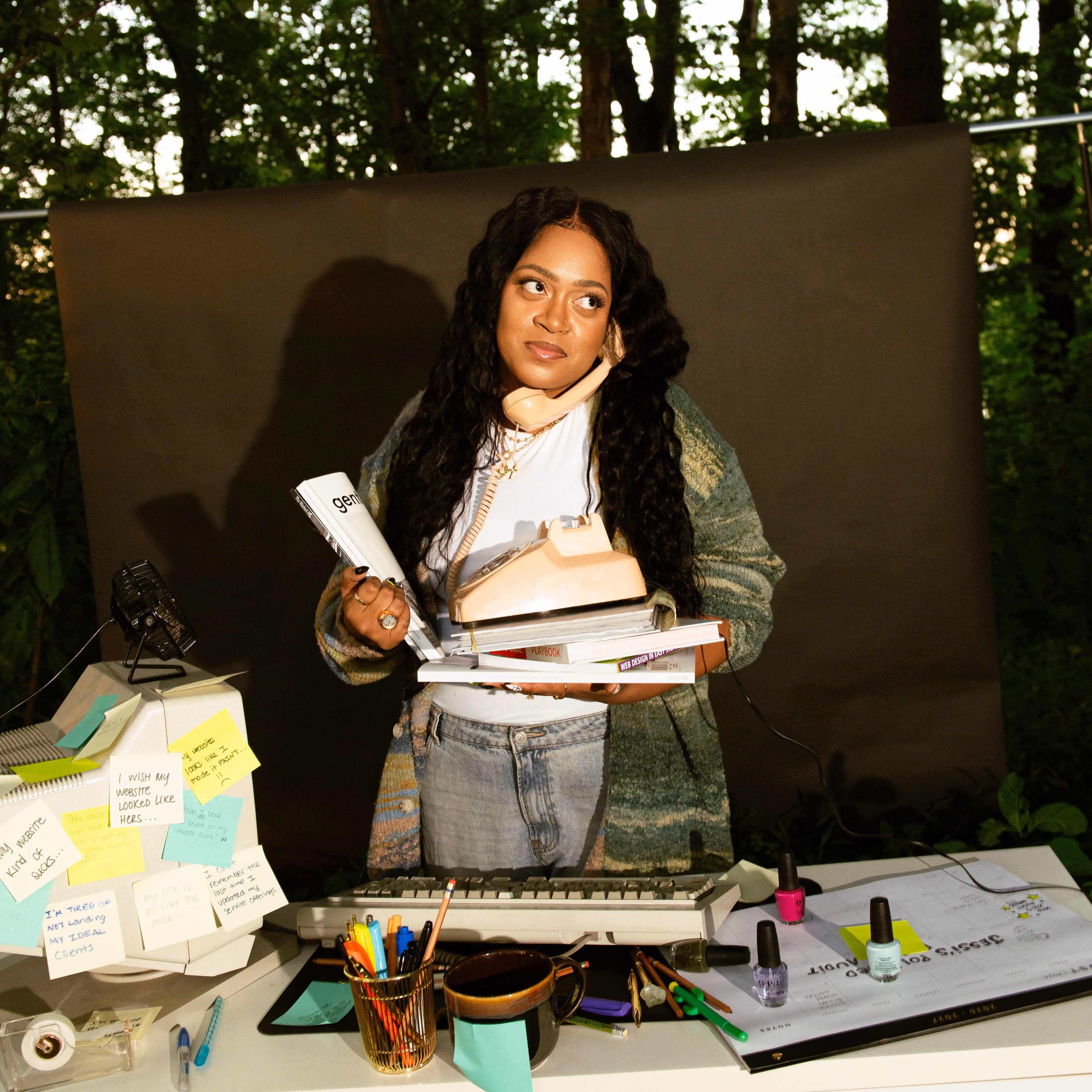 Domanique Taylor resting her chin on her hand while reading through papers at her outdoor desk