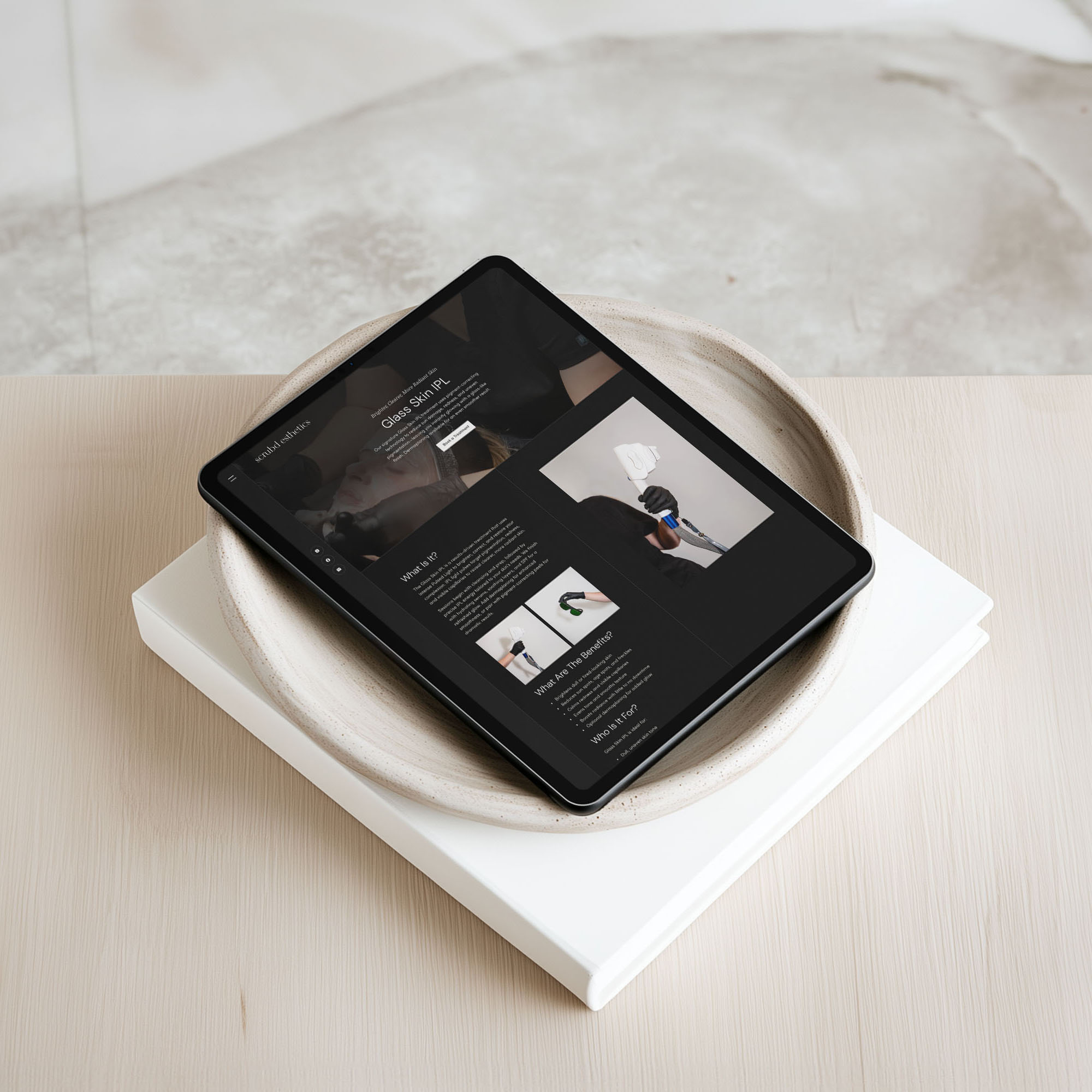 Scrubd Esthetics med spa laser treatment page design shown on a tablet resting in a ceramic dish, with the headline "Glass Skin IPL"