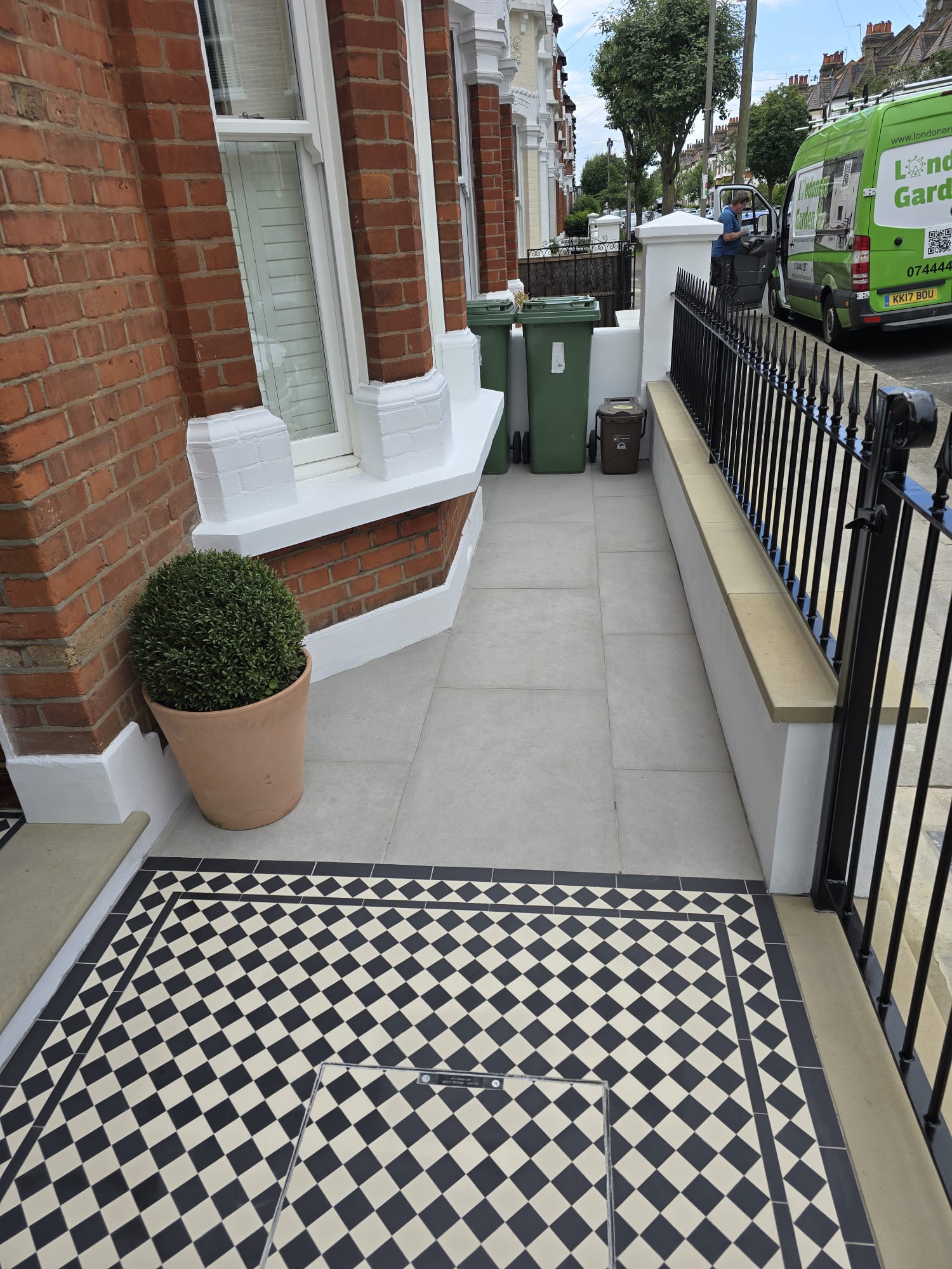 Porcelain front garden paving with metal railings in Clapham SW11