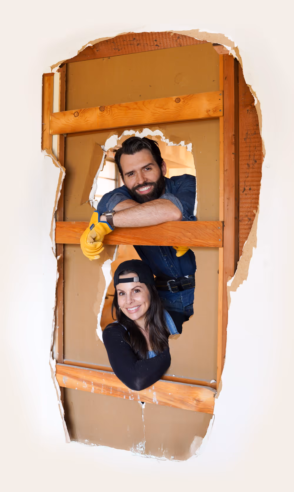 Coco And Cash in a house on demo day, seeing them through a wall with destroyed Drywall and wood studs