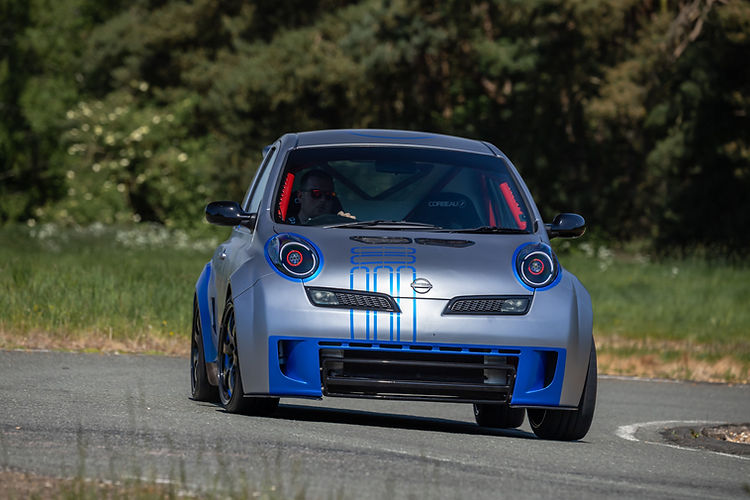 In action on track: 2025 Nissan Micra 350SR updated for its 23rd anniversary with satin silver wrap, blue accents, and refreshed detailing by Nissan Design Europe.