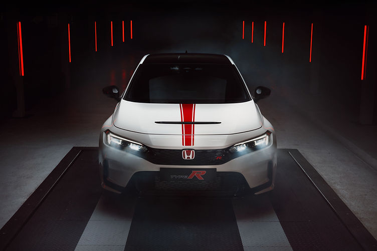 Honda Civic Type R Ultimate Edition in Championship White with red decals and black roof, photographed from head on view.