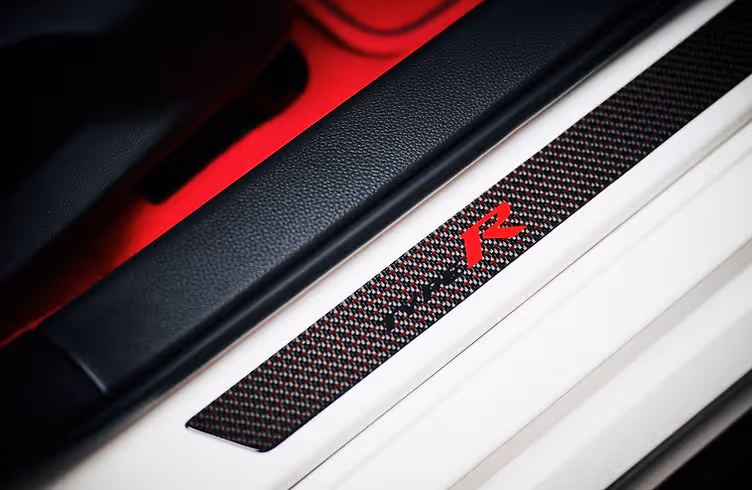 Interior of the Civic Type R Ultimate Edition featuring carbon centre console, red ambient lighting and Alcantara trim.