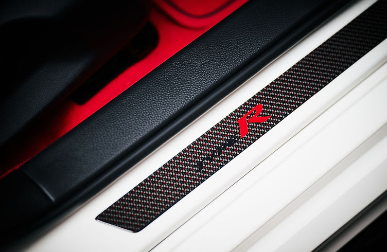 Interior of the Civic Type R Ultimate Edition featuring carbon centre console, red ambient lighting and Alcantara trim.