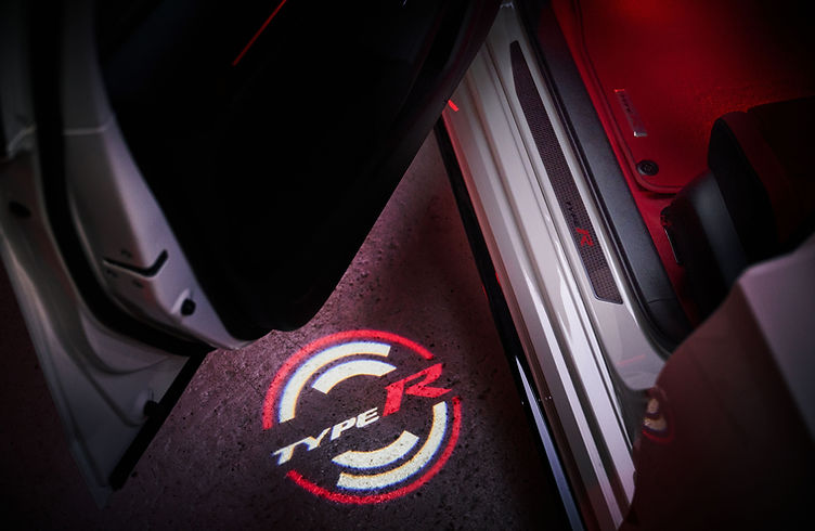 Interior of the Civic Type R Ultimate Edition featuring carbon centre console, red ambient lighting and Alcantara trim.