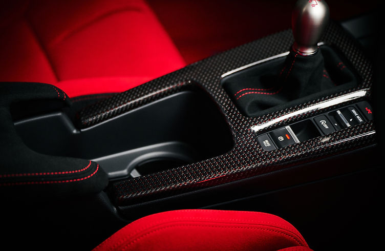 Interior of the Civic Type R Ultimate Edition featuring carbon centre console, red ambient lighting and Alcantara trim.