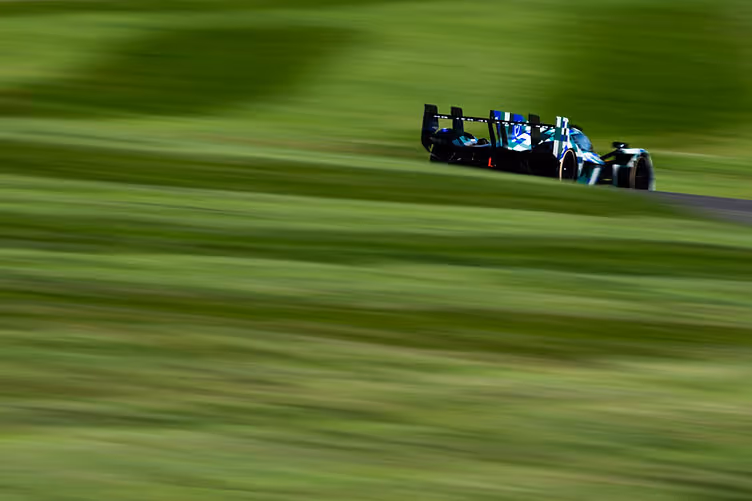 A grass mound obscuring the Aston Martin Valkyrie AMR-LMH's rear