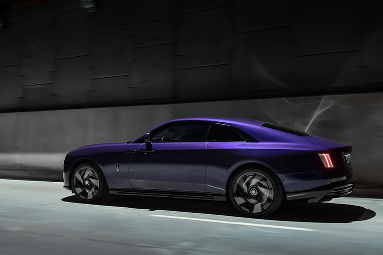 2025 Rolls-Royce Spectre Black Badge driving rear