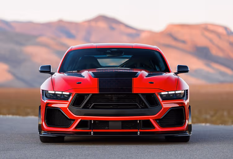 Front view of the Shelby Super Snake-R highlighting the aggressive grille, carbon bonnet vent, front splitter and wide stance, set against a desert mountain backdrop.