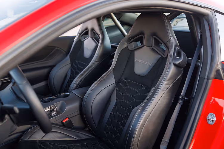 Interior of the Shelby Super Snake-R featuring leather and Alcantara bucket seats with Shelby embroidery, visible harness bar and track-ready cabin layout.