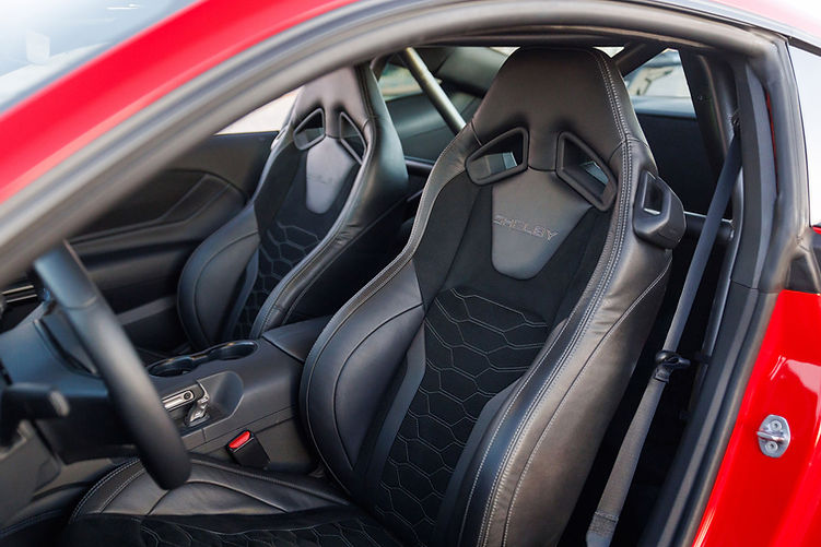 Interior of the Shelby Super Snake-R featuring leather and Alcantara bucket seats with Shelby embroidery, visible harness bar and track-ready cabin layout.