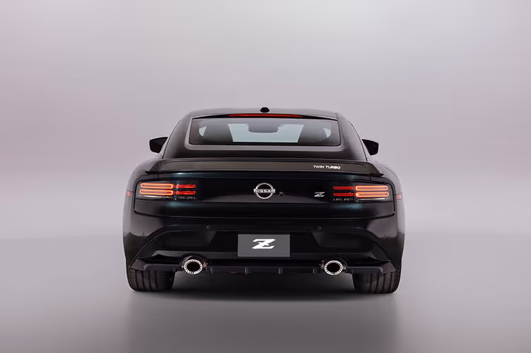 The 2026 Z Heritage Edition recreates the iconic Nissan 300ZX with a carbon-fiber rear spoiler featuring a retro-styled “Twin Turbo” badge and bronze “Twin Turbo” graphics on the body sides.