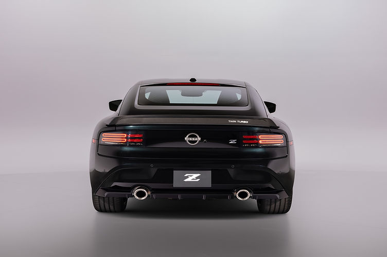 The 2026 Z Heritage Edition recreates the iconic Nissan 300ZX with a carbon-fiber rear spoiler featuring a retro-styled “Twin Turbo” badge and bronze “Twin Turbo” graphics on the body sides.