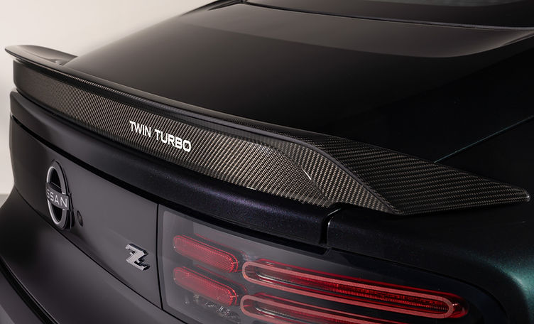 The rear of the 2026 Z is influenced by the Z32, including its elongated-oval tail light shapes and blacked-out center section.
