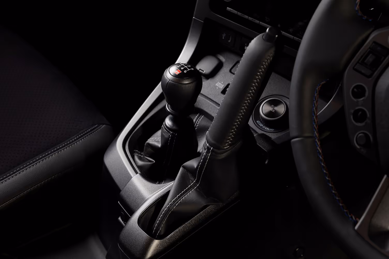 GR Yaris six-speed manual gearbox with vertical handbrake and tricolour stitching