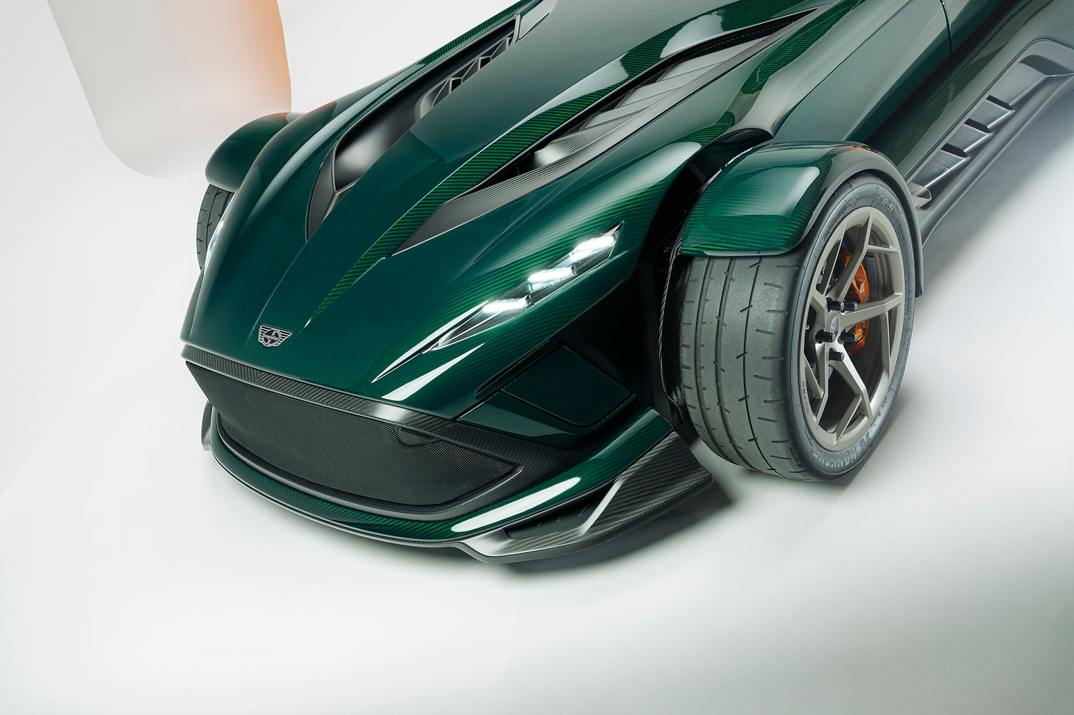 Donkervoort P24 RS front three-quarter view showing optional front wing elements and swing-out headlights