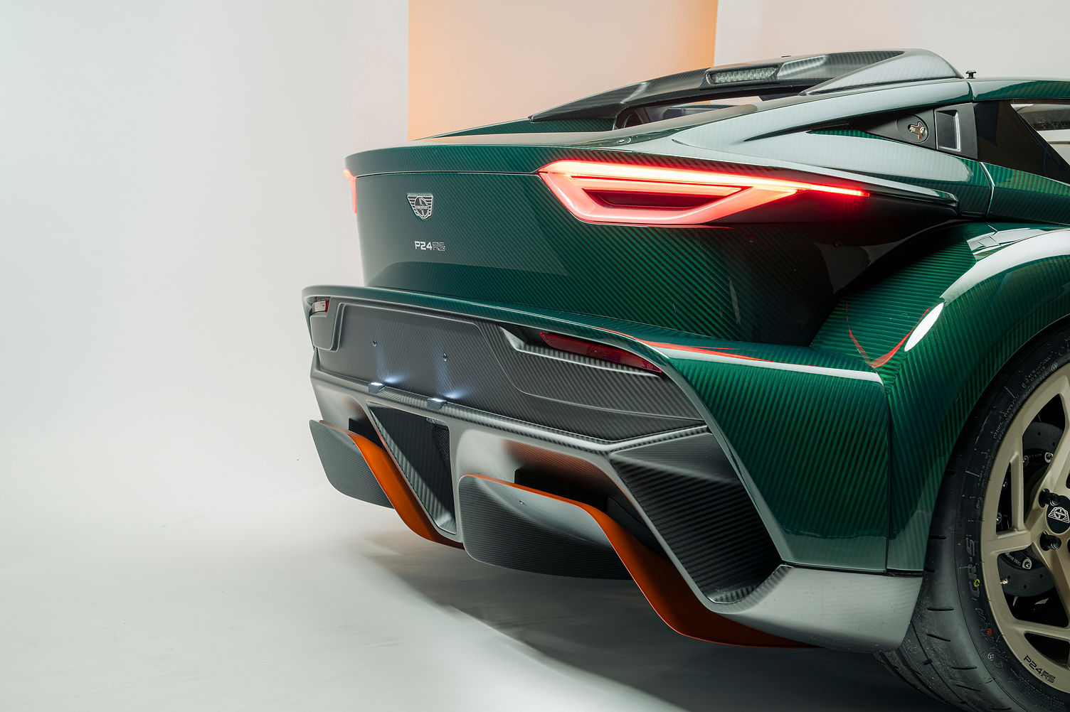 Donkervoort P24 RS rear three-quarter view with optional corner wings and titanium scuff blocks