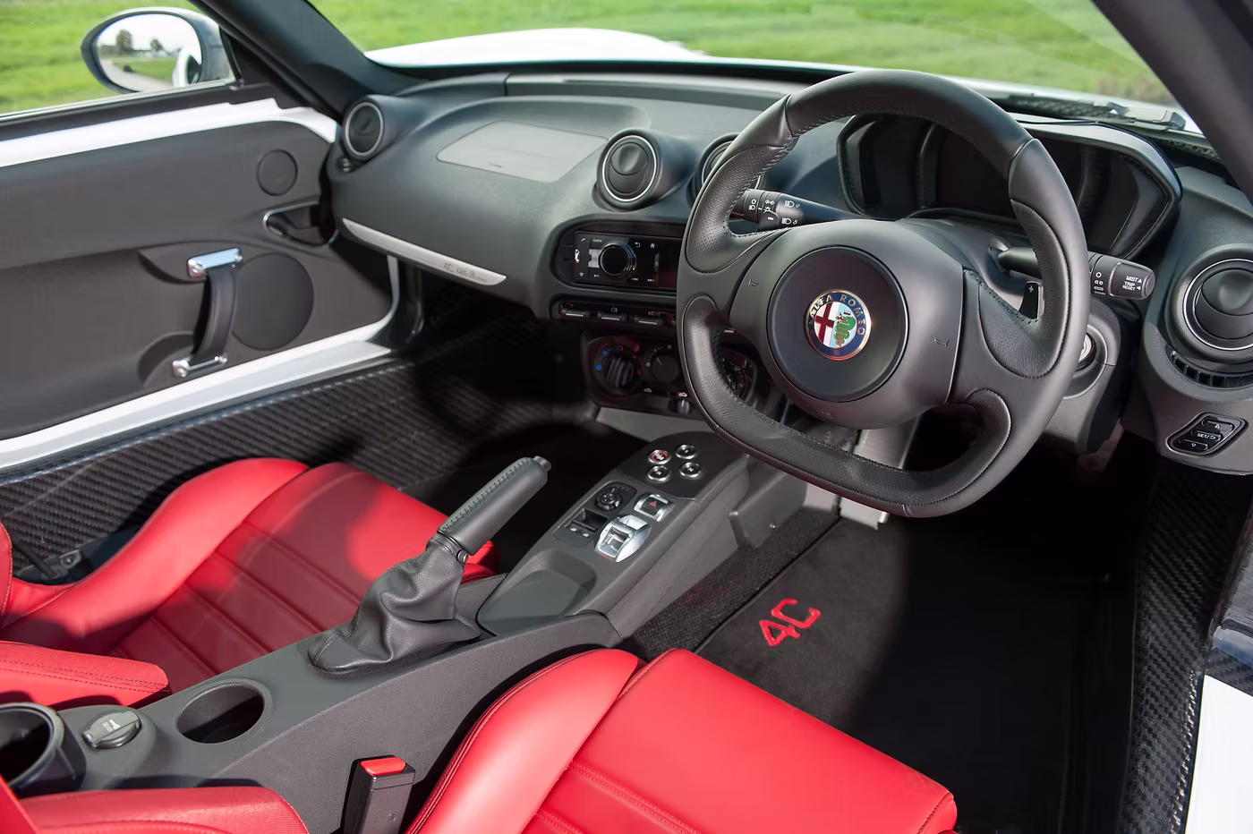 Interior shot of an Alfa Romeo 4C with red leather - Rush magazine buyer's guide