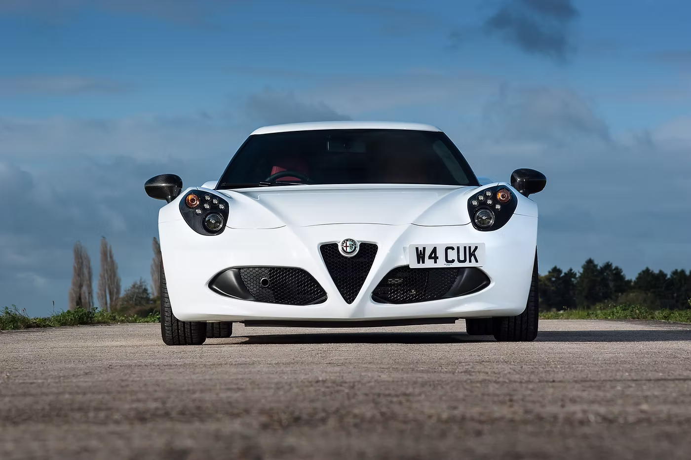 Face on shot of a white Alfa Romeo 4C - Rush magazine buyer's guide