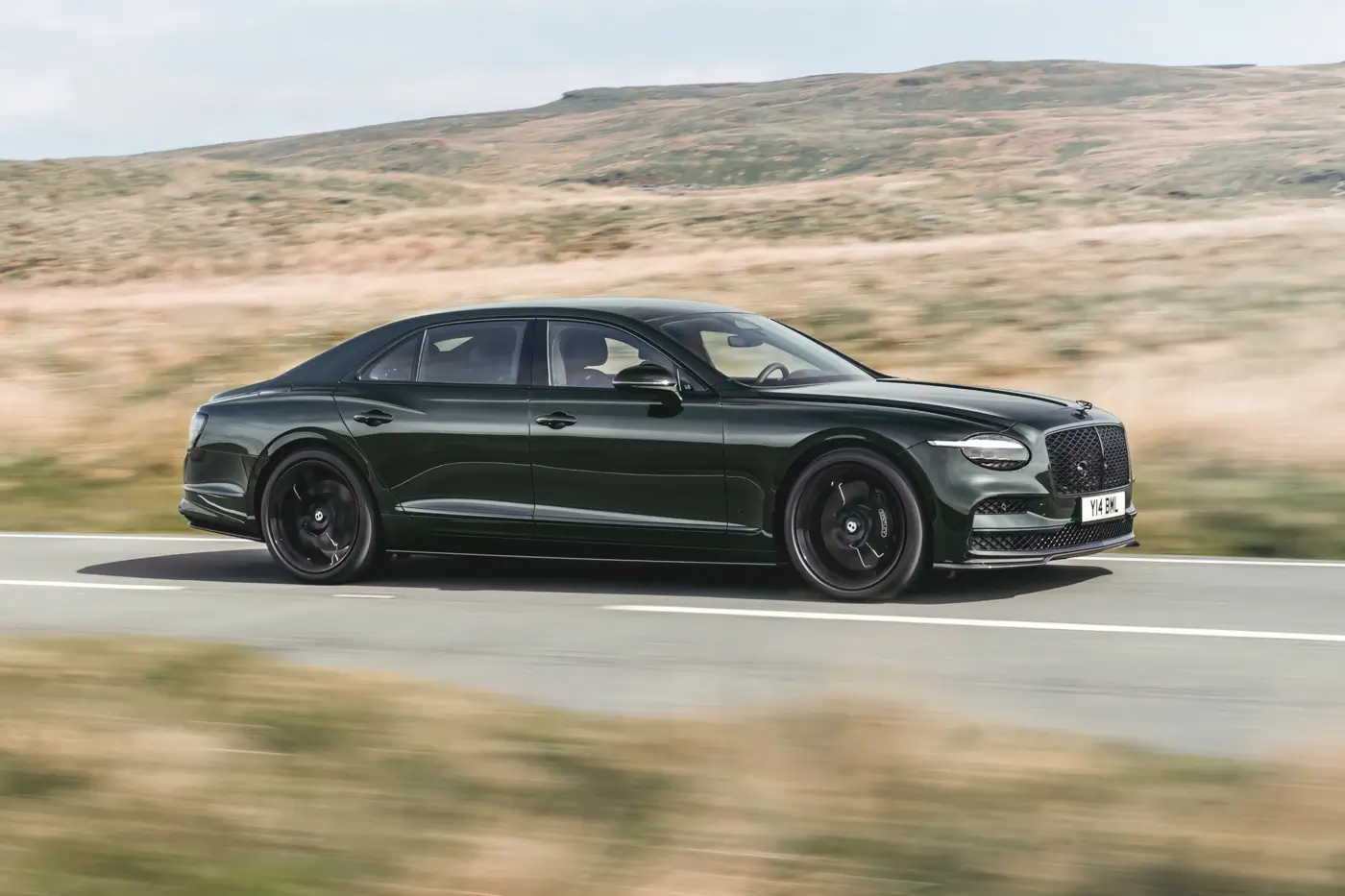 2026 Bentley Flying Spur S side profile in motion on open road