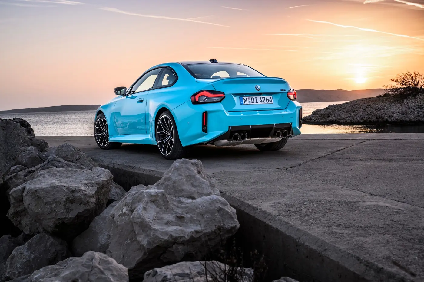 BMW M2 with M xDrive rear three-quarter static shot at sunset in Borusan Turkish Blue