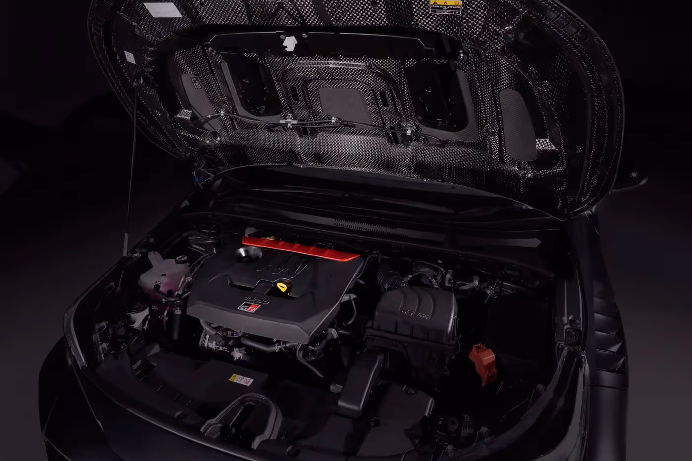 Toyota GRMN Corolla engine bay with carbon fibre bonnet underside