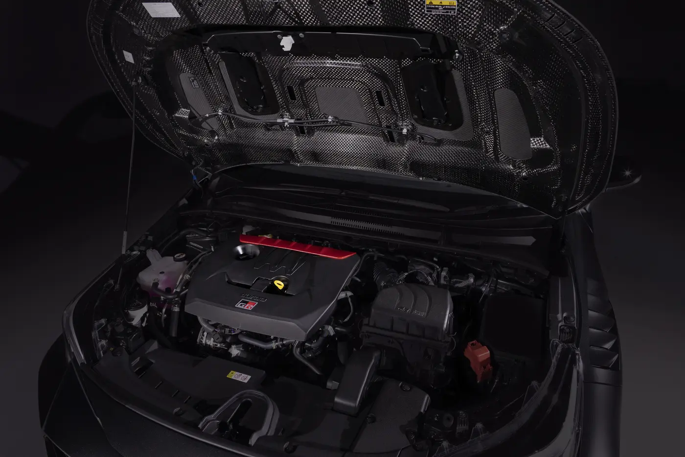 Toyota GRMN Corolla engine bay with carbon fibre bonnet underside