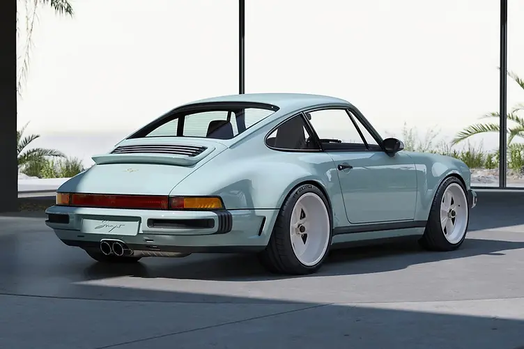Singer's latest reimagined 911 blends wide-body '80s looks with a 4.0L VVT flat-six, hybrid cooling, and F1-grade chassis tech from Red Bull. Rear three quarter view