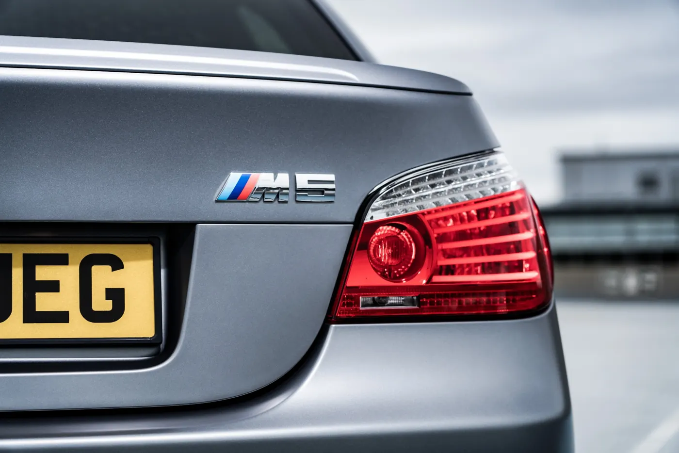 Close up of E60 M5 badge with iconic M division blue, purple, and red tricolour