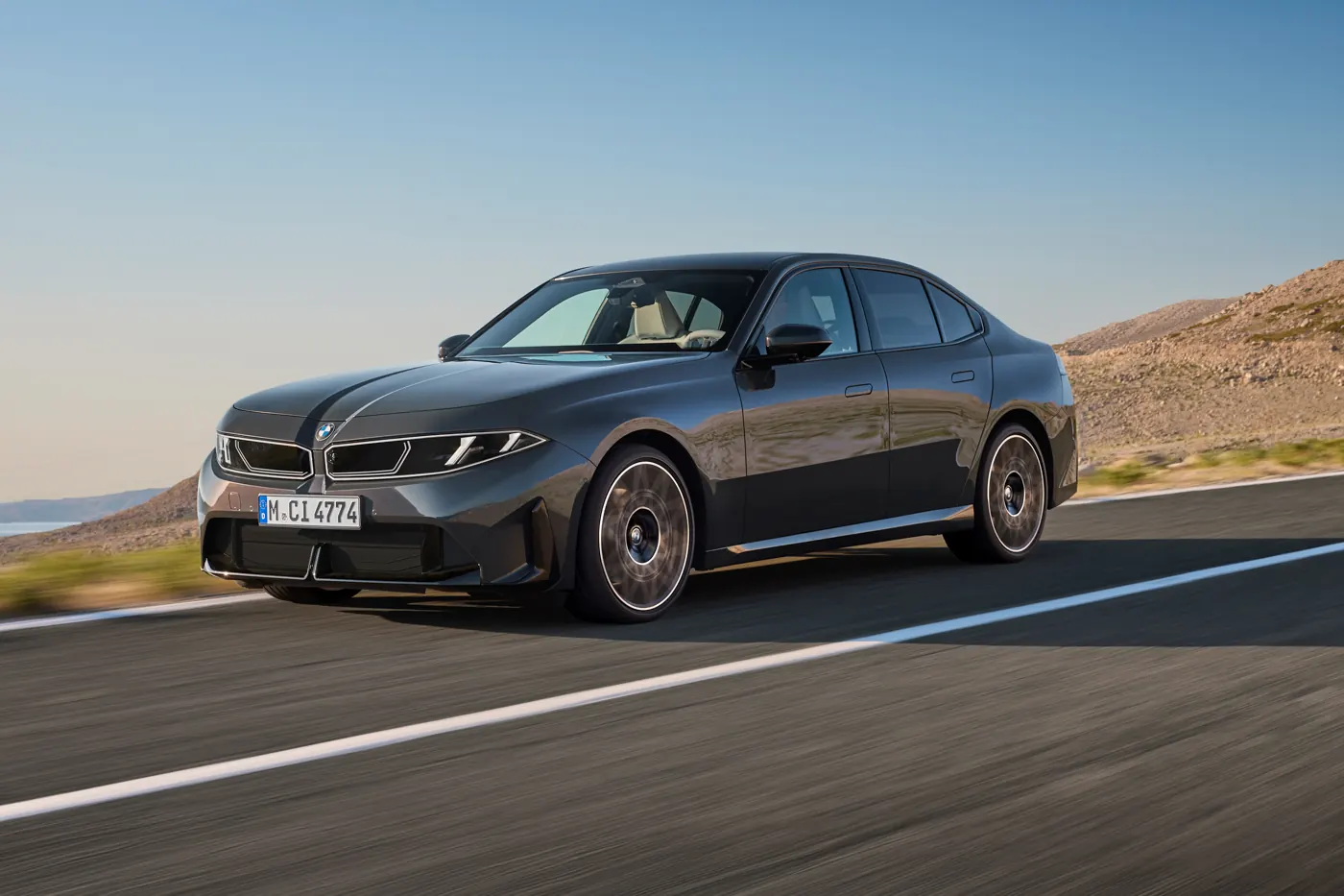 Grey BMW 320 G50 driving, front three-quarter of the new entry-level 3 Series