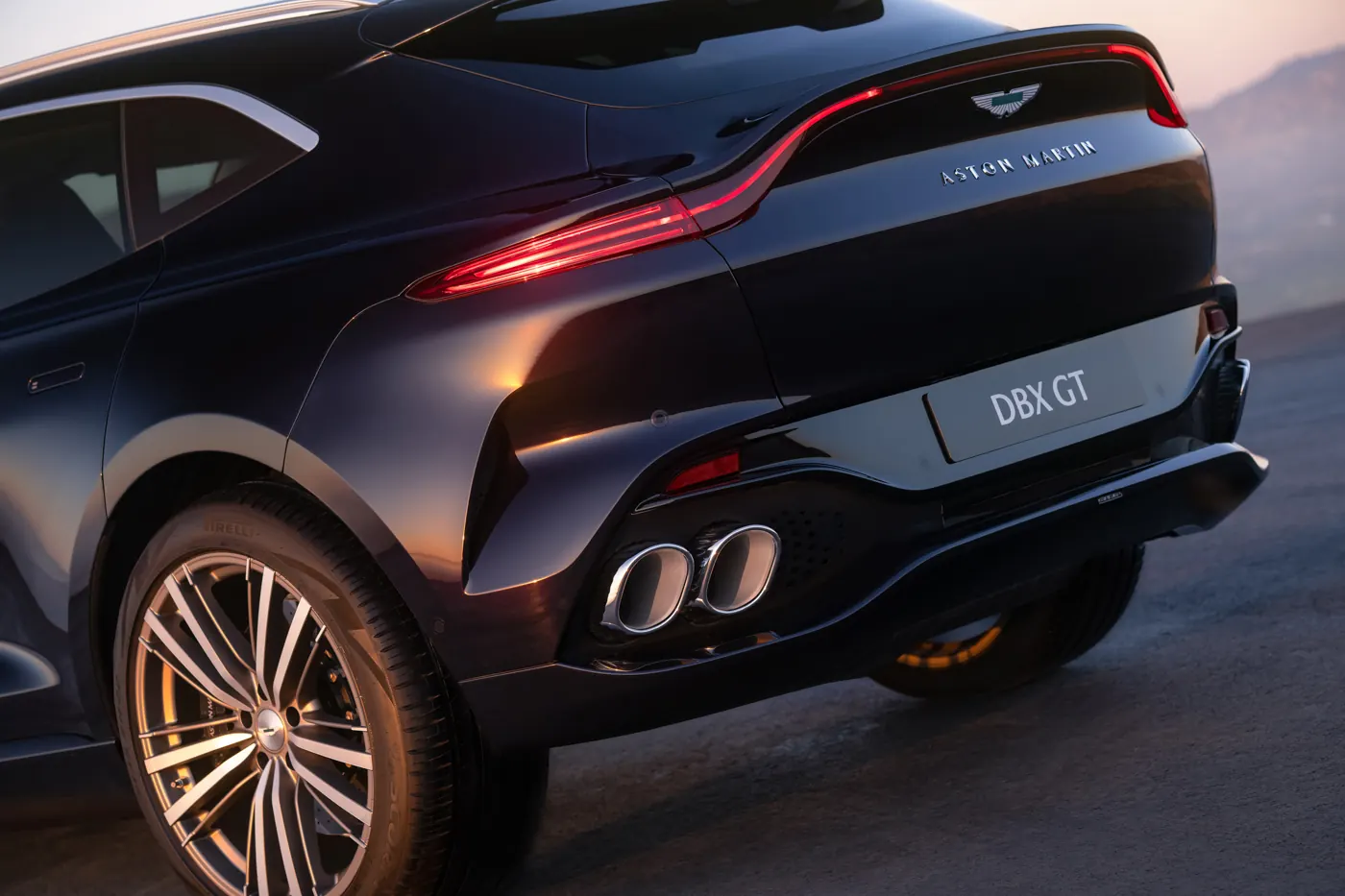 Close-up of the Aston Martin DBX GT rear quarter, showing the tail-light, DBX GT badge and twin exhaust outlets