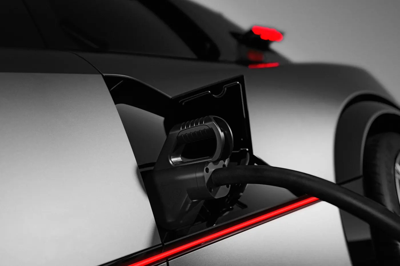 Charging cable plugged into the Peugeot E-T16 Concept's port, housed in the intake ahead of the rear wheel.