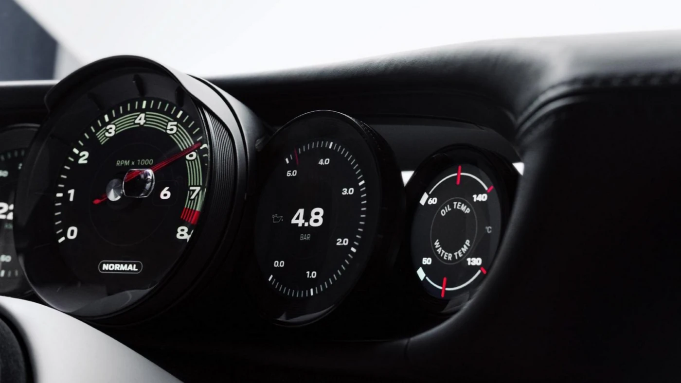 Angled close-up of the Mission S digital dials: rev counter, oil pressure, and oil and water temperature