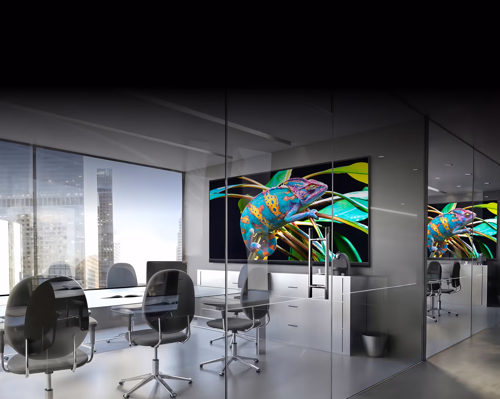 An office with a glass wall and a large painting on the wall.
