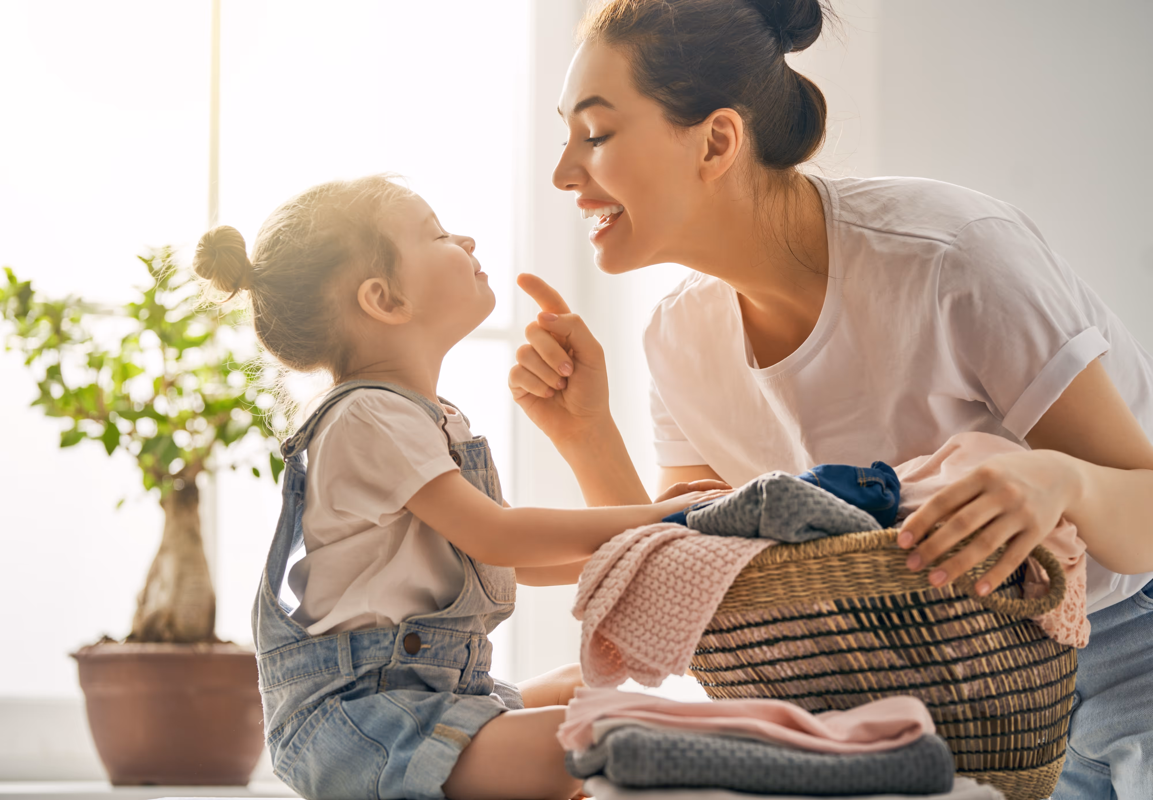 Mom and daughter with laundry stock image